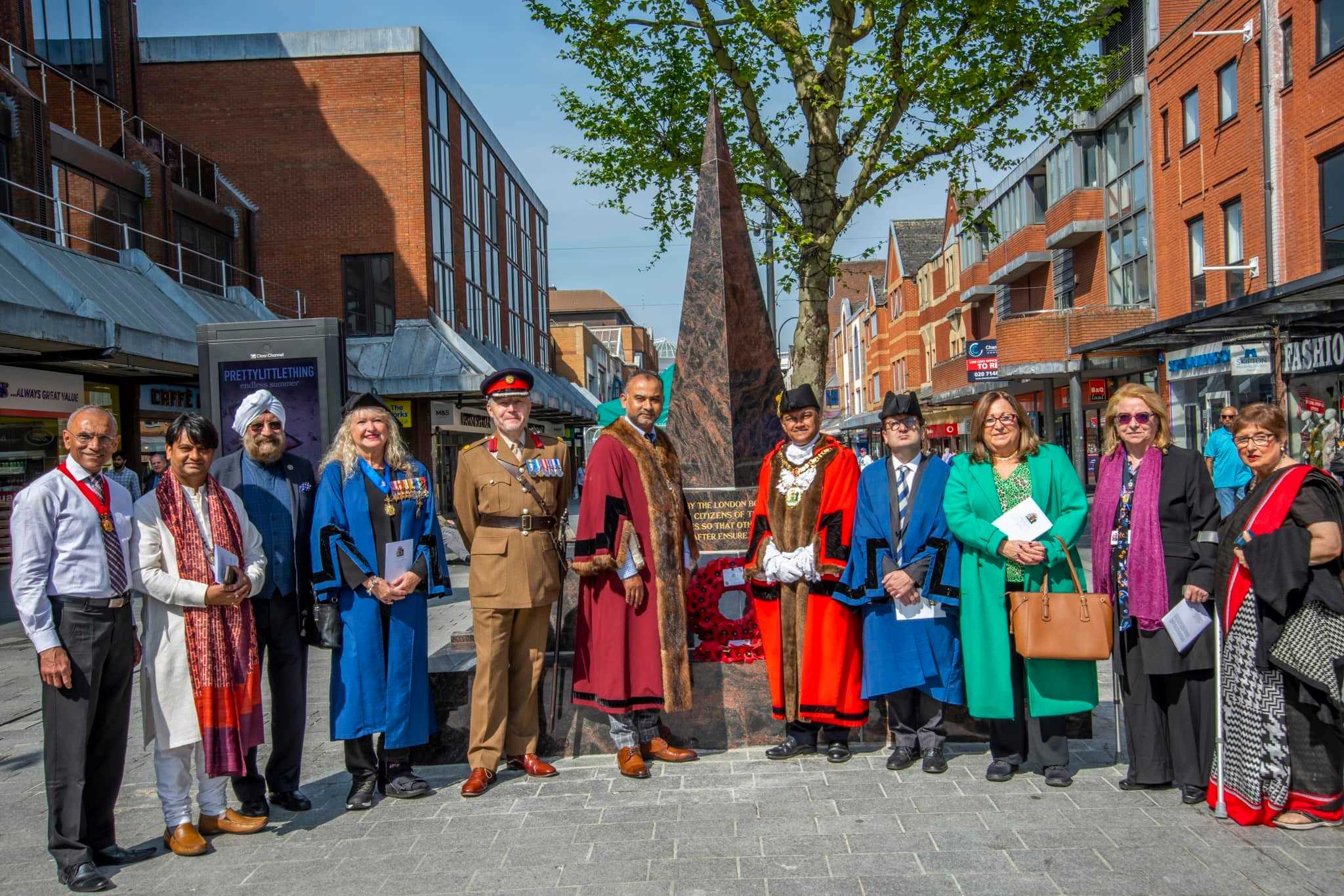 Multi faith leaders, Councillors, The Mayor of Harrow and Leader of The Borough of Harrow take a picture by the war memorial in Harrow Town Centre