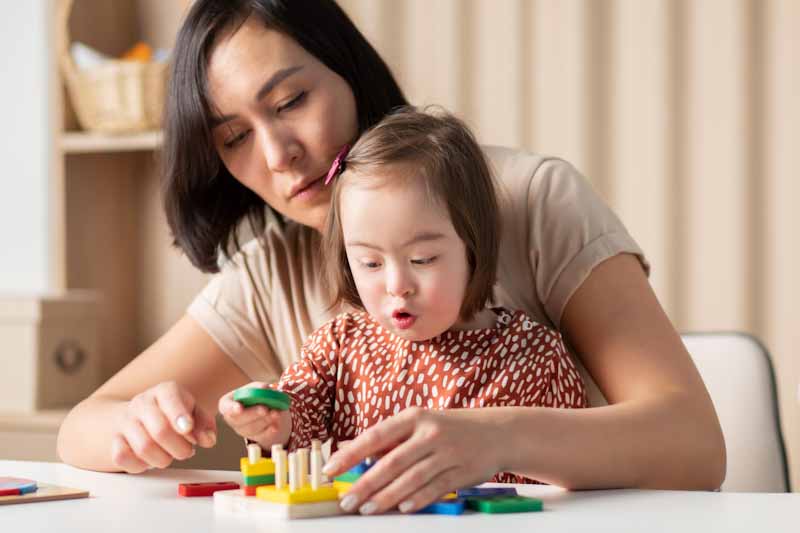 Parent and child playing with wooden blocks